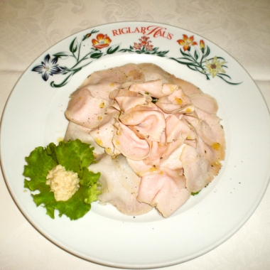 Smoked pork filet on a bed of valerian leaves